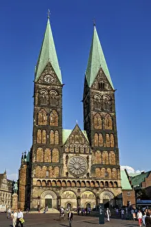 Gothic cathedral with two towers and clock under a clear sky