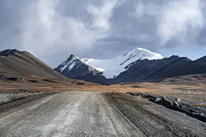 Gravel road through autumnal plateau