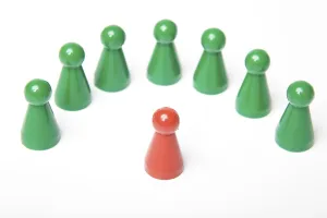 Green gaming pieces standing around a single red gaming piece