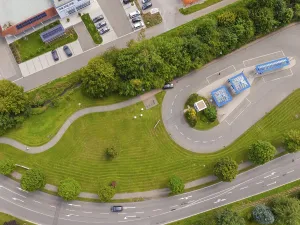 Green parkland with winding footpaths and the surrounding road network