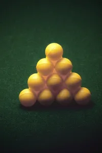 Green poker felt table cloth and ball arranged as pyramid