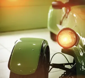 Green retro car headlight. Retro postcard of the vintage car