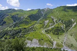 Framed Print : Green valley with mountains and river under blue sky and few clouds