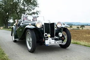 Green vintage car MG driving and from the front