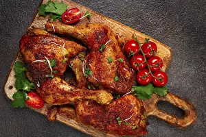 Grilled fried chicken legs, served with fresh cherry tomatoes