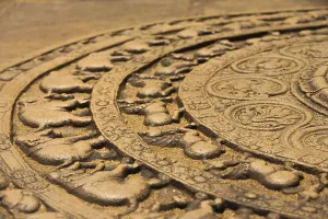 A ground carving at the entrance to the Vatadage is a moonstone relief depicting the cycle of sansara in the ruins of