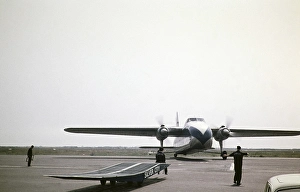 Ground crew directing Bristol Superfreighter aircraft G AMWE, Silver City Airways airline ferry, Ferryfield Airport, Lydd Airfield, Kent England, UK 1960