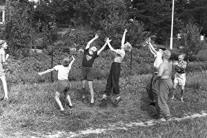 A group of boys playing outdoors, trying their best to reach the thrown ball first. 1954 Kristoffersson ref DV1