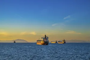 A group of four cargo freighters floating at anchor outside of Nanaimo harbour