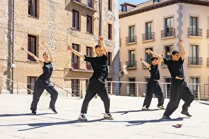 Framed Print : Group of diverse urban dancers performing synchronized street dance movements with raised arms Framed Print : Group of diverse urban dancers performing synchronized street dance movements with raised arms