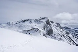 Group of lonely ski tourers in a snowy mountain landscape