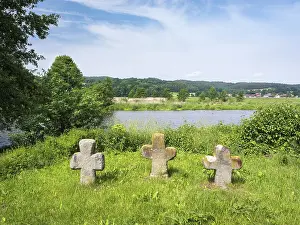 Group of three medieval stone crosses on the banks of the river Naab