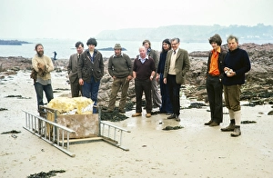 A group of people pose on the beach with the bone of a mammoth skull found at La Cotte de St Brelade, Ouaisne Bay, Jersey, Channel Islands in 1976, Europe