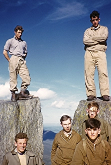 Group of young male climbers standing high on a rock, probably North Wales, United Kingdom, c. 1958, Europe