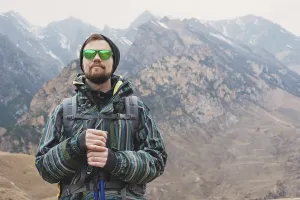 A guy with a beard and wearing sunglasses in a membrane jacket