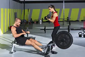 Gym couple with dumbbell weights and fitness power workout