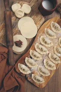 Gyoza cooking, on a cutting board