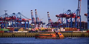 HADAG's harbour ferry MS Kehrwieder in front of the container gantry cranes at the Burchardkai container terminal