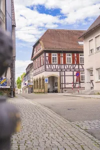 Half-timbered building on a cobbled street under a blue sky