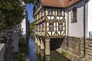 Half-timbered hospital building on piles in the water