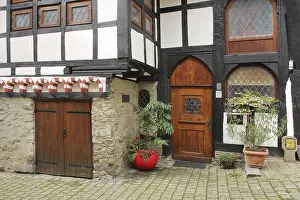 Half-timbered house built in 1292 with wooden door and decoration