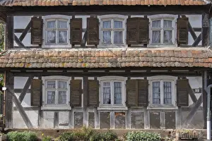 Half-timbered house, dilapidated facade with windows
