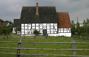 Half-timbered house under a stormy sky