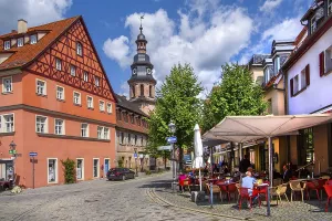 Half-timbered house with street cafe and hospital church in the old town
