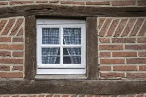 Framed Print : A half-timbered house window with wooden beams and blue checkered curtains Framed Print : A half-timbered house window with wooden beams and blue checkered curtains
