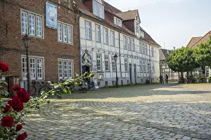 Category Cities DE Prints: Half-timbered houses with red roses in a cobbled courtyard