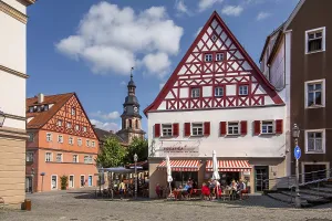 Half-timbered houses with street cafe and hospital church in the old town