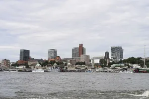 Hamburg harbour view with ships and clock tower by day