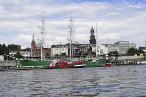 Hamburg harbour view with ships and clock tower by day