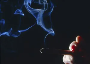 Hand with burning cigarette