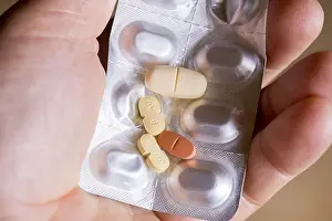 Hand holding a blister pack with tablets