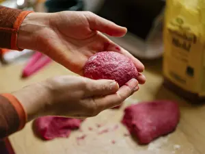 Hand moulding the dough for beetroot burger buns