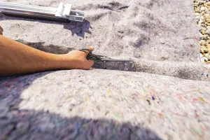 Hand with a tool, placed on a textured surface
