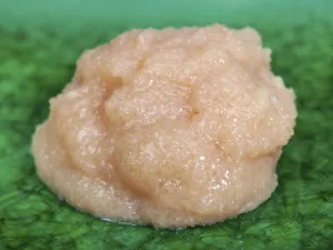 Handful of salty caviar of cod fish on green plate