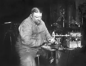 Handicraft, fat man working on a grinding machine