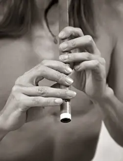 Hands of the musician playing on his wind instrument