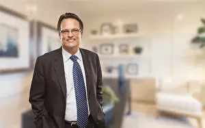 Handsome businessman in suit and tie standing in his office