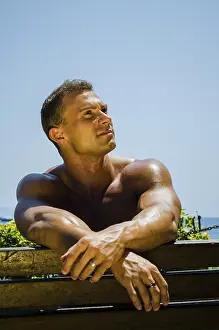 Handsome Muscular Shirtless Hunk Man Outdoor at Seaside Looking at Camera