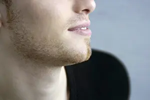 Handsome profile smile portrait young man face detail closeup