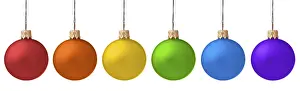 Several hanging Christmas baubles isolated on white background