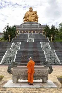Happy Buddha, monk at an altar