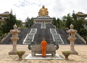 Happy Buddha, monk at an altar