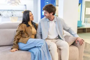 Happy couple enjoying the comfort of a new couch