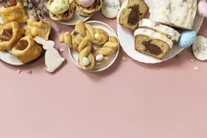 Happy Easter holiday food baking puff pastry and cupcake with Easter Bunny on pastel pink background