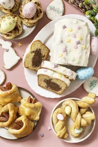 Happy Easter holiday food baking puff pastry and cupcake with Easter Bunny on pastel pink background