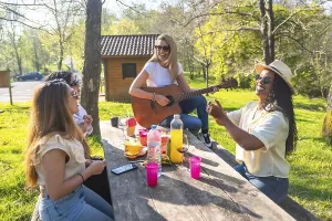Happy friends are having a picnic in a park